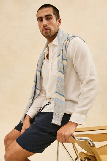 Wyatt Classic Button Up Long Sleeve Relaxed fit Shirt in White - stylized side angle view on model, leaning on chair