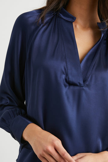 Wynna Long-Sleeve Top with a Deep V Neck and Ruching above the Cuffs and at the Neckline in Navy Colorway - Front View Featured on Model