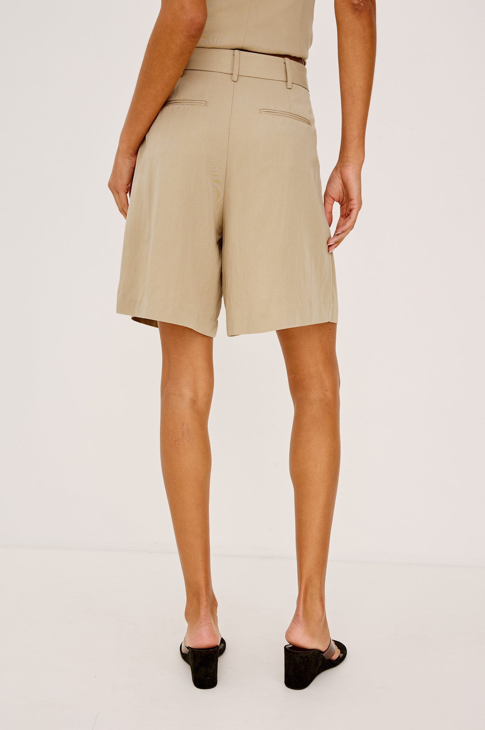 Zamora High-Waisted Bermuda Short in Linen Viscose With Front Pleats and Side Pockets in Almond Colorway - Lower Body Back View Featured on Model