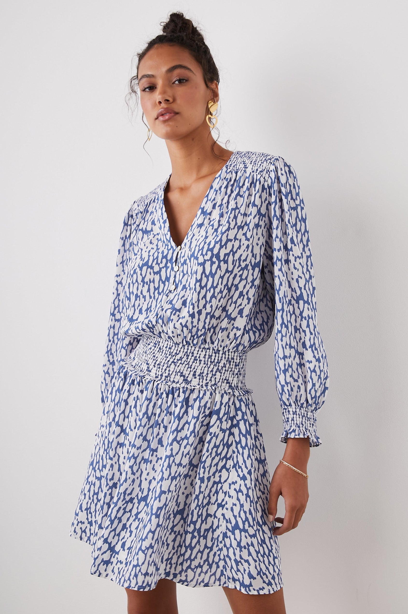 Zana Long-Sleeve Mini Dress with a V Neck, Smocked Cuffs and Waist, and Buttons Down the Bodice in Cobalt Static Leopard Colorway, a White and Cobalt Spotted Print - Front View Featured on Model
