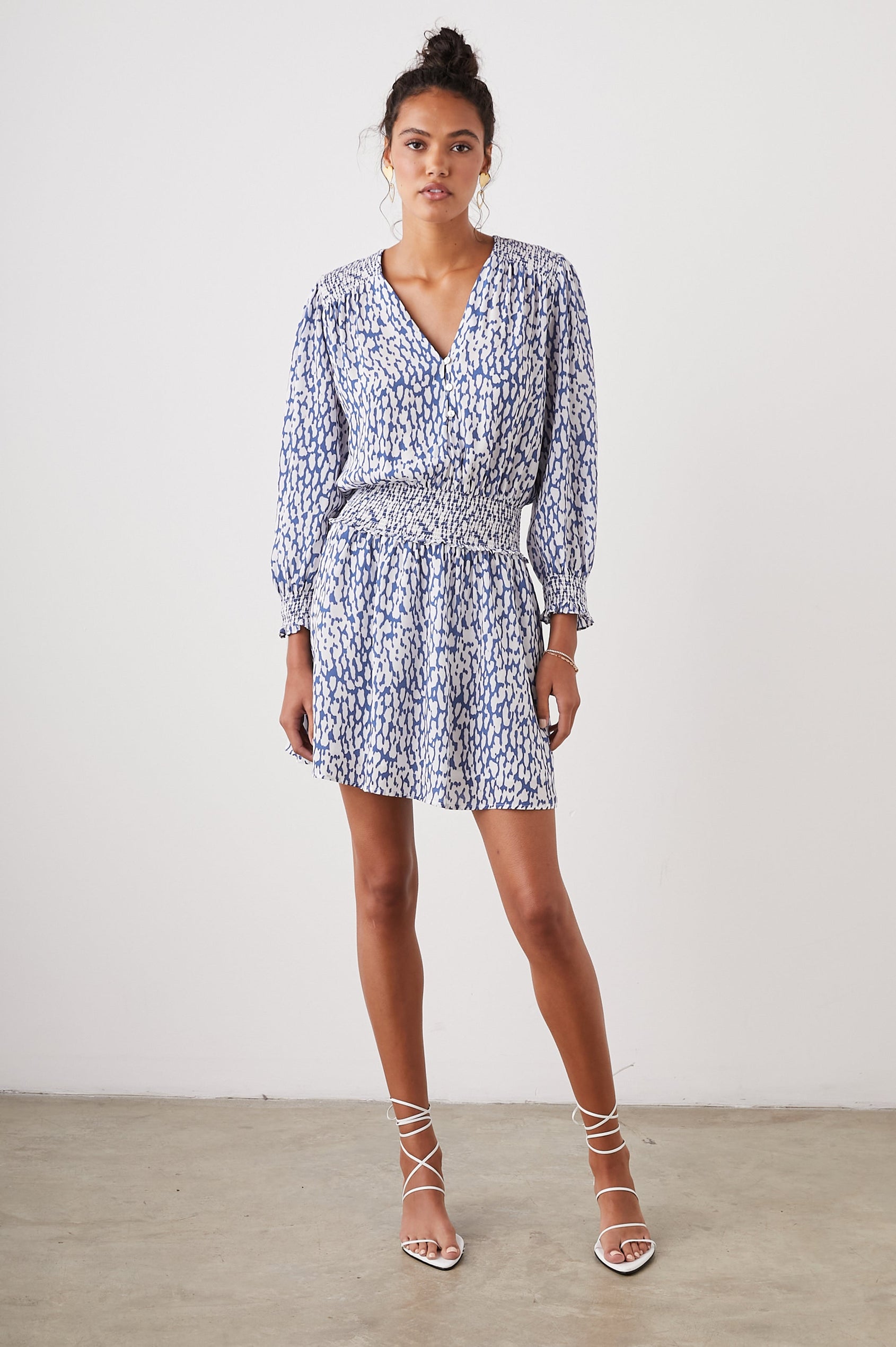 Zana Long-Sleeve Mini Dress with a V Neck, Smocked Cuffs and Waist, and Buttons Down the Bodice in Cobalt Static Leopard Colorway, a White and Cobalt Spotted Print - Front Full Body View Featured on Model