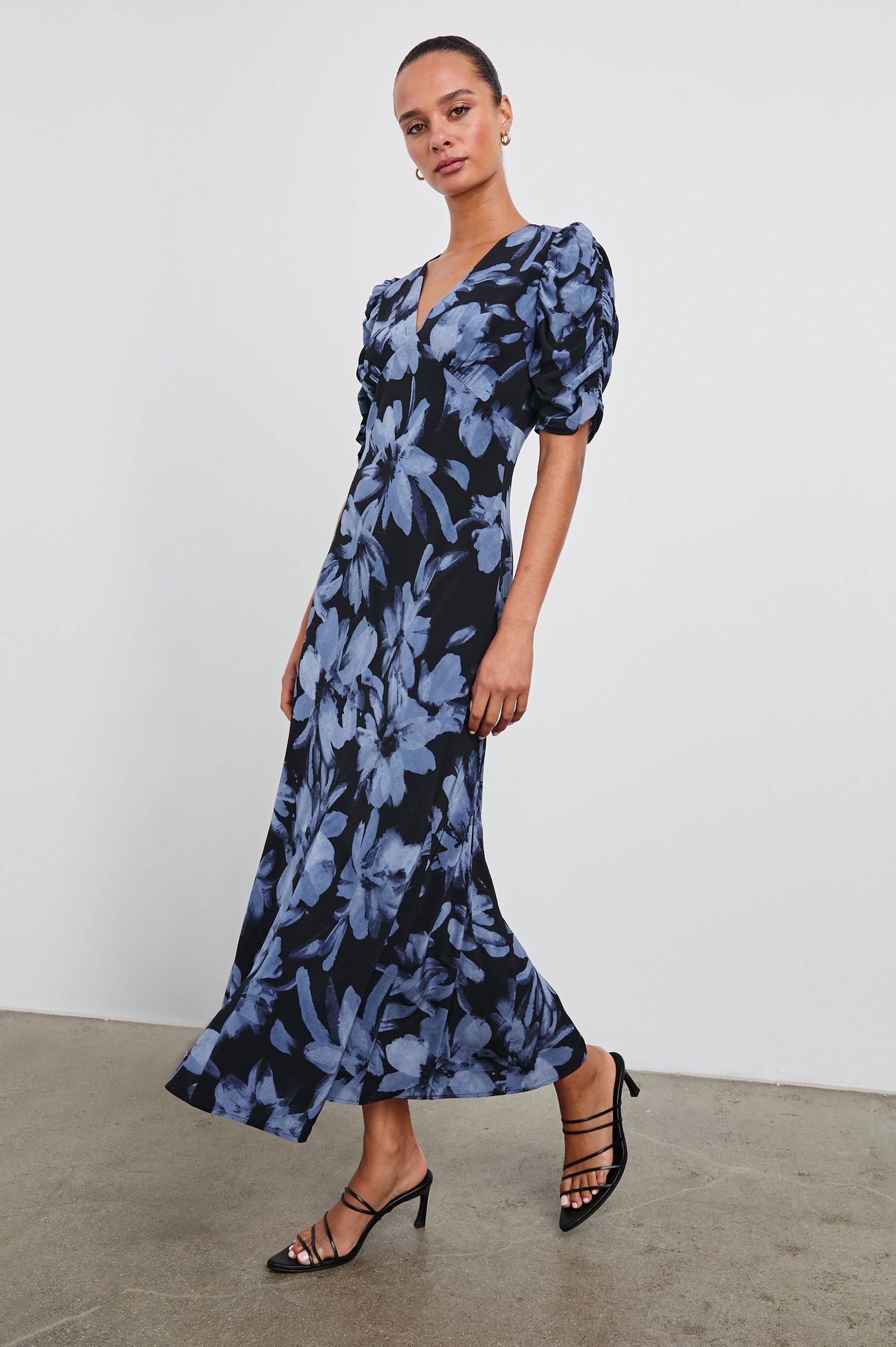 Zariah Midi Dress with Mid-Length Sleeves with Light Ruching, a Deep V Neck and an Empire Waist in Midnight Lily Colorway, with flowers in blues on midnight - Front Full Body View Featured on Model