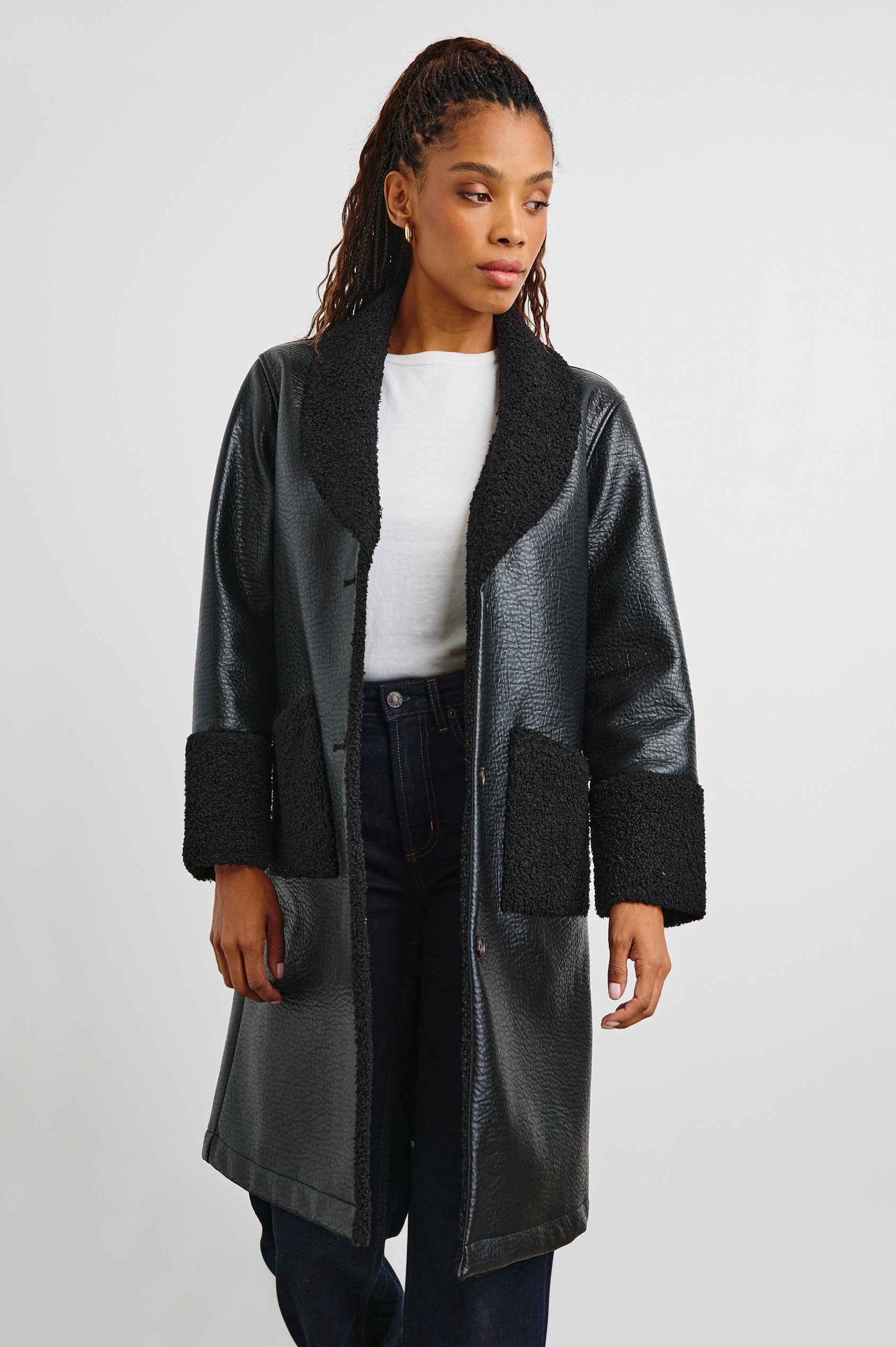 Zodiac Jacket with Button Closure Starting at the Mid-Chest and Two Front Patch Pockets in Black Shearling Colorway, with the Collar, Cuffs and Pockets in Faux Shearling - Front View Featured on Model