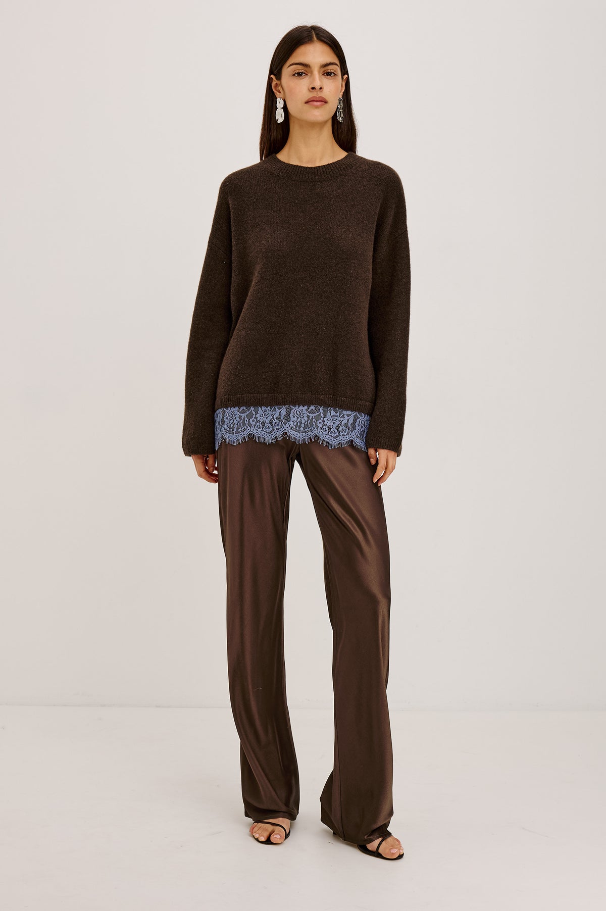 Zoie Sweater in Merino Wool Blend With Contrast Lace Inset Hem for Layered Look, Long Sleeves, and Slightly Oversized Fit in Espresso Blue Lace Colorway - Full Body Front View Featured on Model.