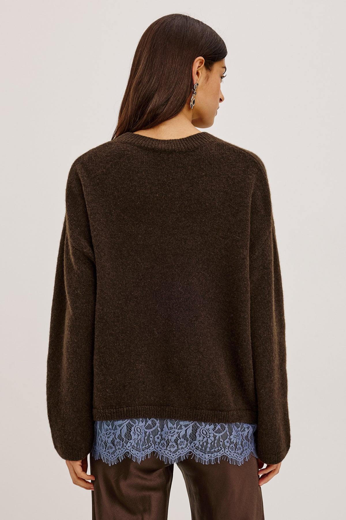 Zoie Sweater in Merino Wool Blend With Contrast Lace Inset Hem for Layered Look, Long Sleeves, and Slightly Oversized Fit in Espresso Blue Lace Colorway - Upper Body Back View Featured on Model.