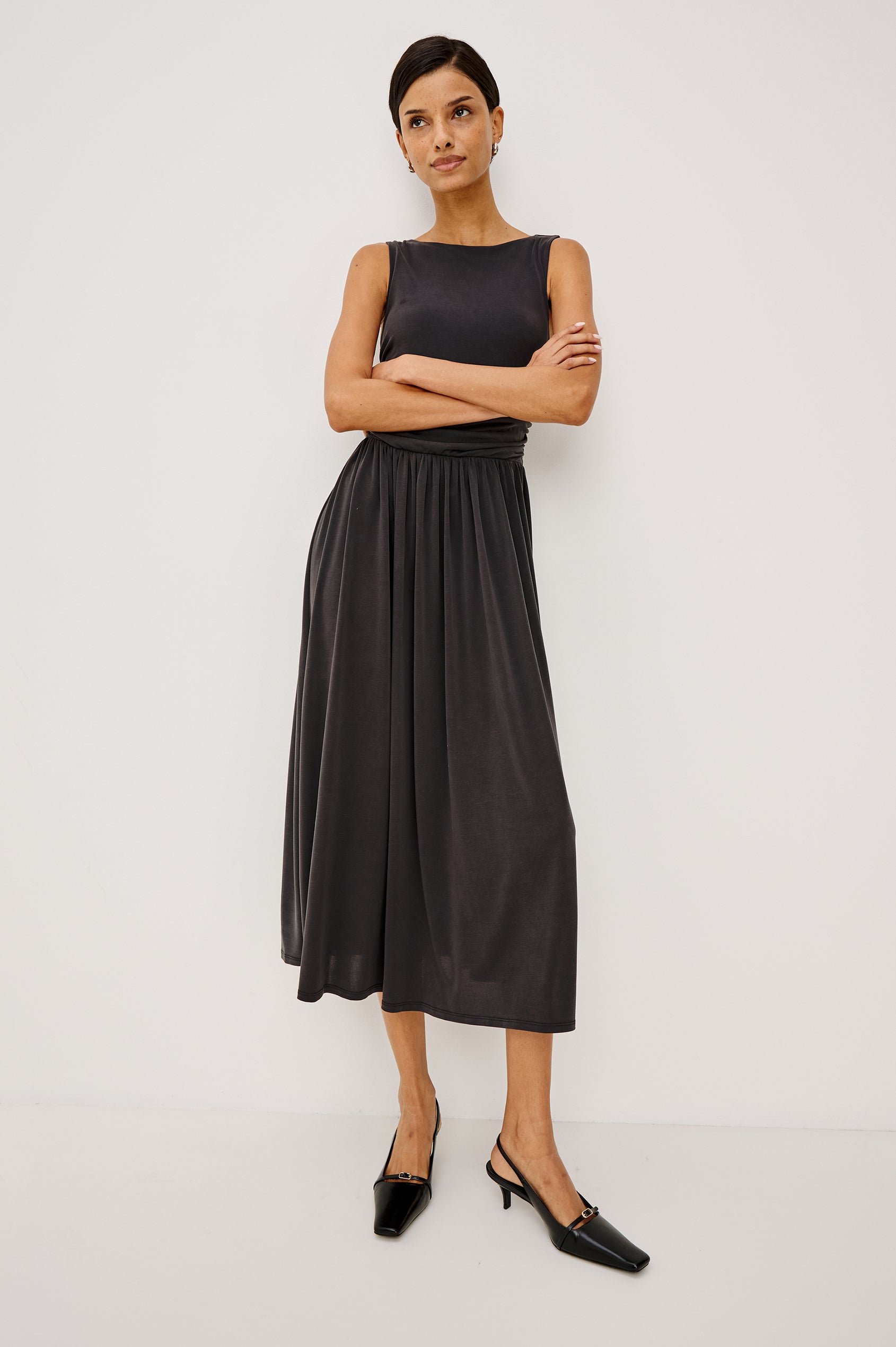 Zora Maxi Dress in Peached Jersey With Fitted Ruched Bodice, Shirred A-Line Skirt, Sleeveless Cut, and Crew Neckline in Ash Colorway - Full Body Front View Featured on Model