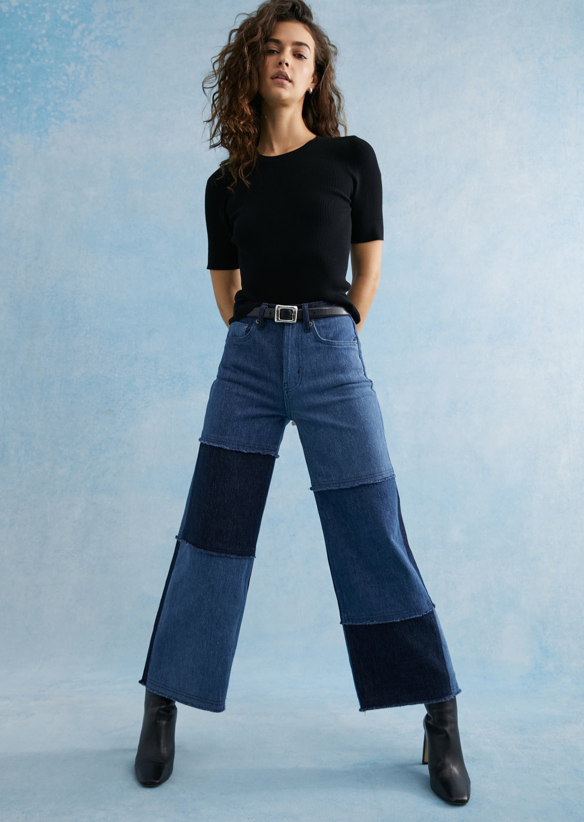 FRONT FULL BODY EDITORIAL IMAGE OF MODEL WEARING GETTY CROP WIDE LEG JEANS IN INDIGO PATCHWORK