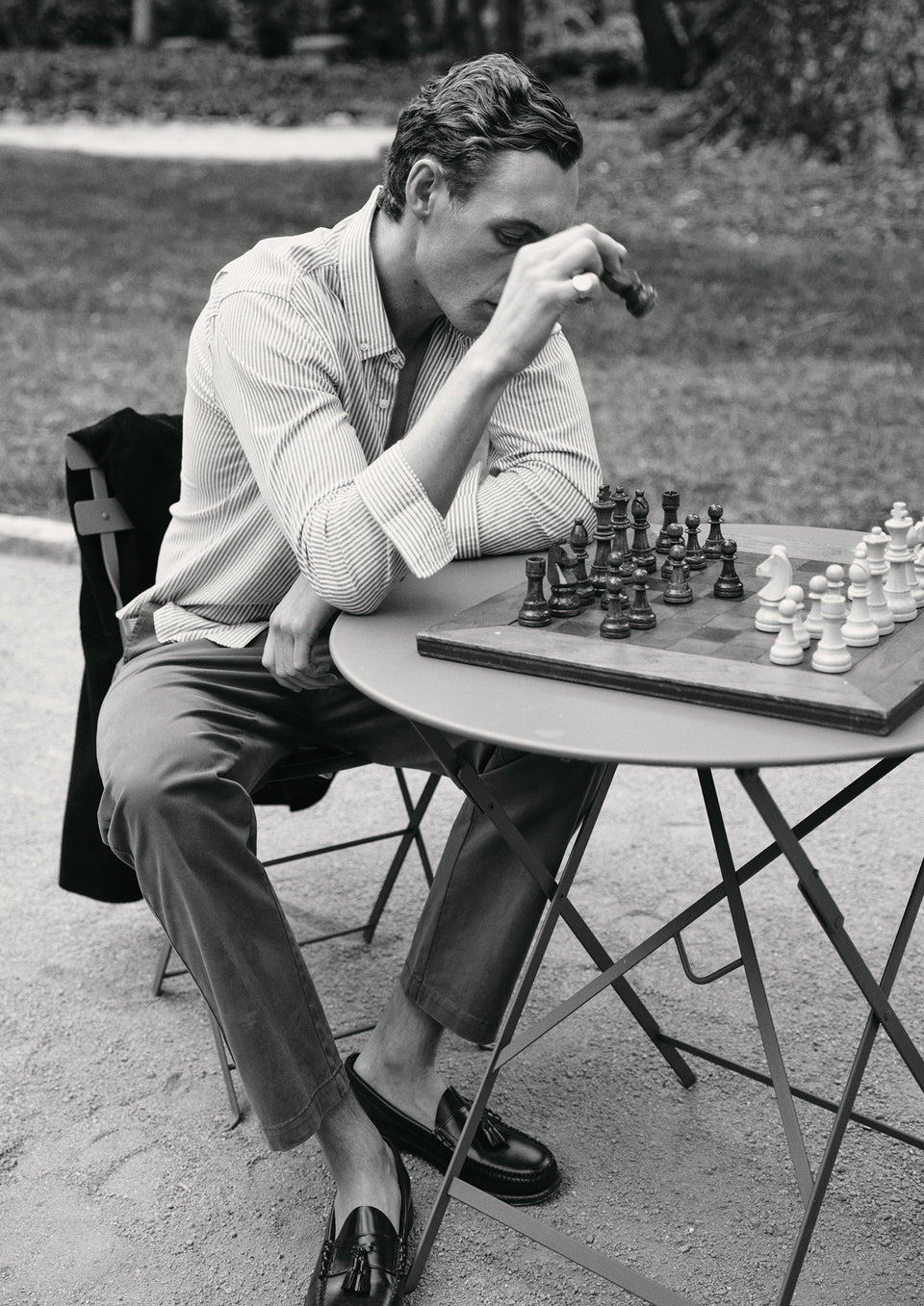 Man playing chess outdoors on a sunny day