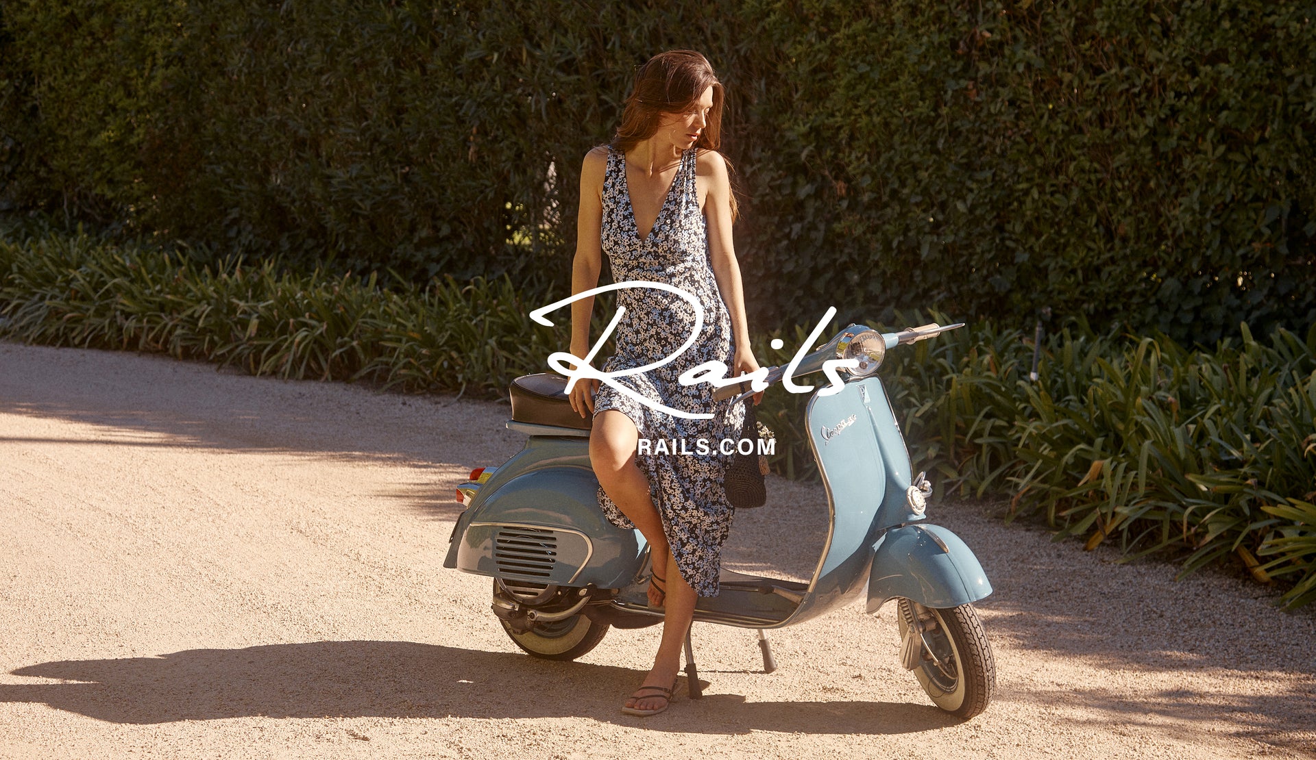 EDITORIAL IMAGE OF MODEL ON VESPA WEARING AUDRINA DRESS