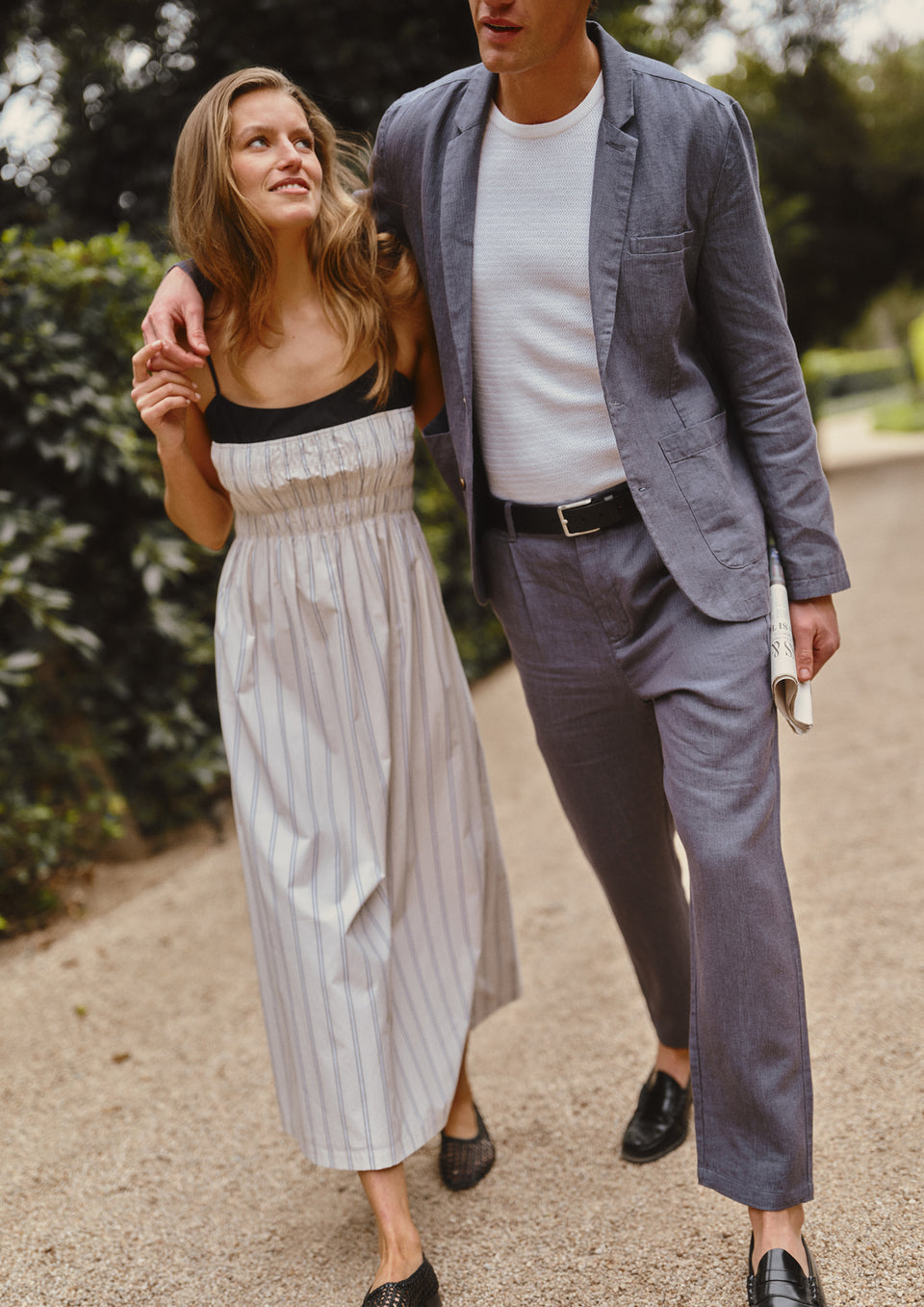 Man and woman walking together in a park-like setting