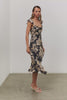 (Video): Marigold dress in Charcoal Lily floral print, showing the movement of the ruffled hem on a model - full body front view featured on model.