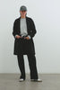 (Video): Everest Black Coat shown on a model to showcase the fit of the heavy wool coat. Full Body View Featured on Model.