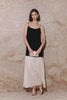 (Video): Model wearing the Chandra midi dress in Black Ivory, demonstrating the movement of the tiered skirt and the fit of the bodice.