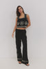 (Video): EMMIE wide-leg pants with sun embroidery, showing the high-waisted fit and breezy silhouette on a model.