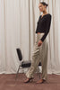 Virgo Pant in Satin-Back Crepe With Straight Legs, Drawstring Waist, and Side-Seam Pockets in Mink Colorway - Full Body View Featured on Model Posing with Chair (Video).