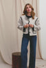 (Video): Melanie Jacket in Oatmeal shown on a model to showcase the heavy wool material, contrast stitching, button details, and boxy fit. Full Body View Featured on Model.