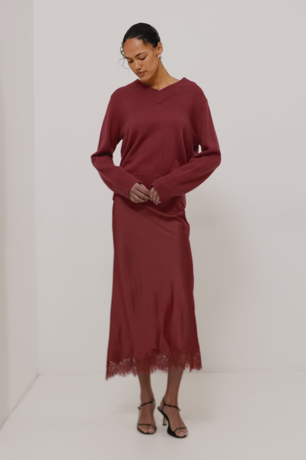 Lidya Sweater in Wool-Cashmere Knit Blend With V-Neckline, Loose Relaxed Fit, Long Sleeves, and Ribbed Trim in Crimson Colorway - Full Body Front View Featured on Model - Video