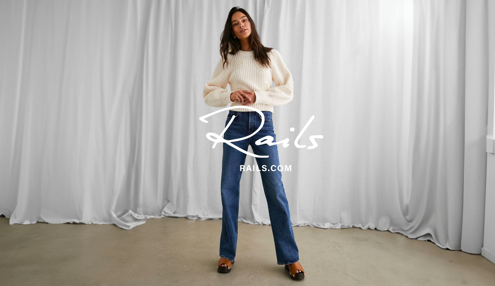 FRONT FULL BODY EDITORIAL IMAGE OF MODEL WEARING ROMY SWEATER AND GETTY WIDE LEG JEANS