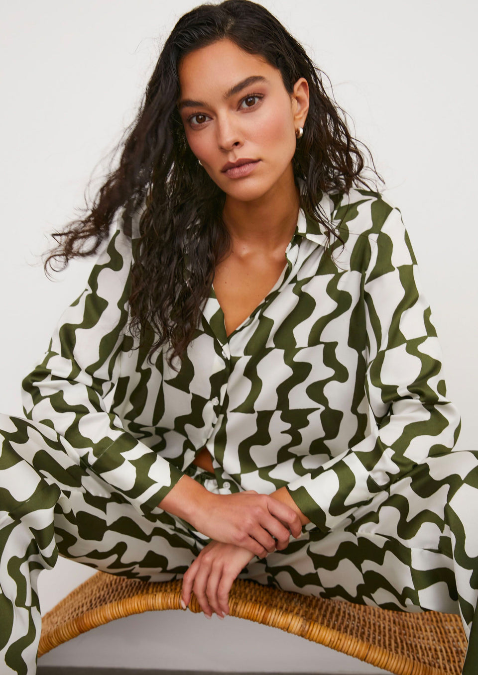FRONT IMAGE OF MODEL SITTING WEARING LEDGER SHIRT AND DAMANI PANT