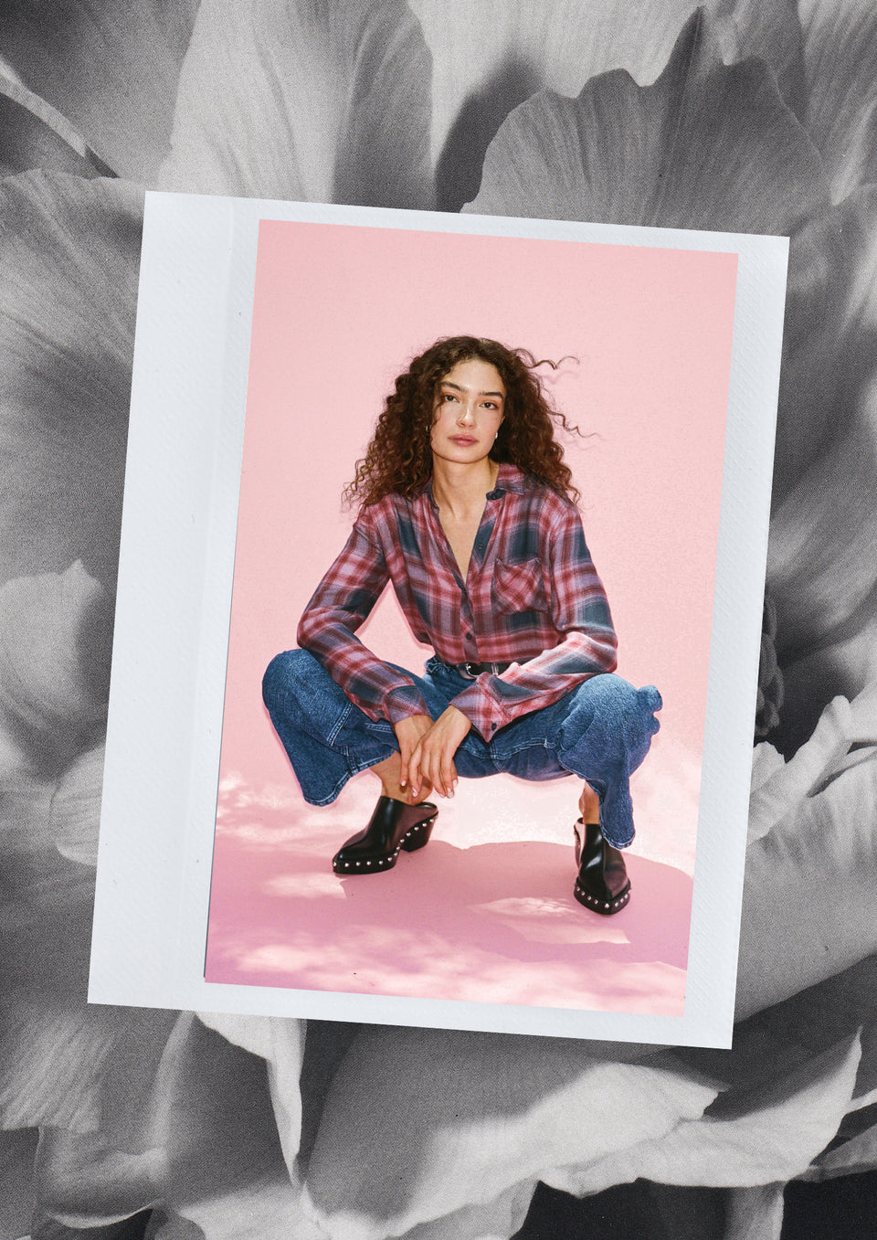 EDITORIAL IMAGE OF MODEL SITTING WEARING HUNTER SHIRT AND GETTY WIDE LEG JEANS