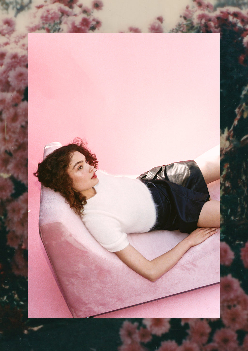 EDITORIAL IMAGE OF MODEL LAYING DOWN WEARING BRIAR TOP AND ADRIANA SKIRT