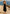FRONT FULL BODY EDITORIAL IMAGE OF MODEL STANDING BY THE OCEAN WEARING JESSA DRESS IN BLACK