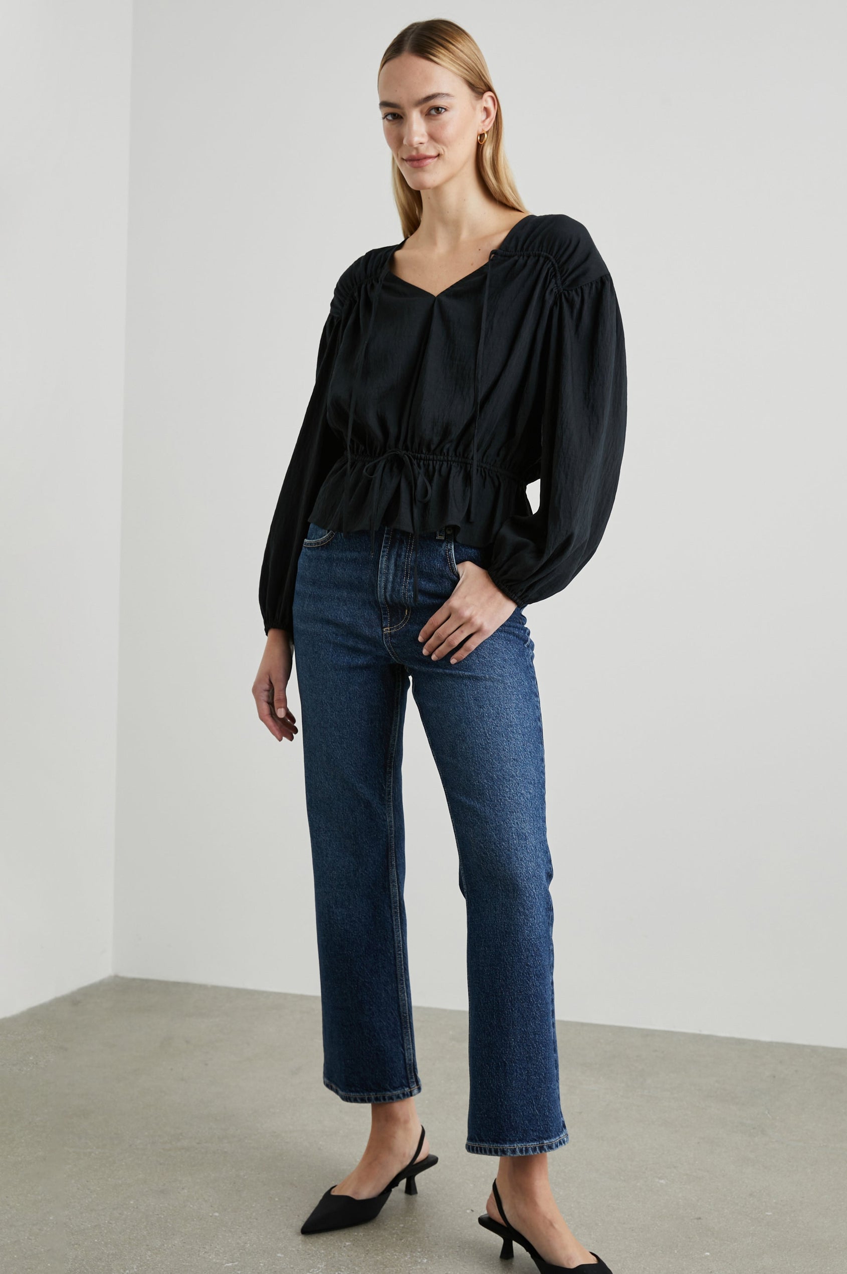 Abra Long-Sleeve Top with a V Neck, a Drawstring From Each Sleeve Shoulder to the Neckline, a Drawstring Above the Hem and Billowy Sleeves in Black Colorway - Front Full Body View Featured on Model 