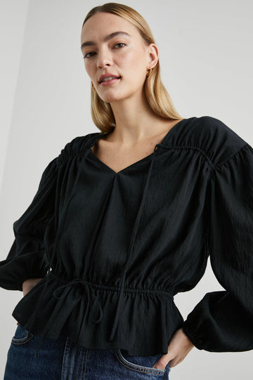 Abra Long-Sleeve Top with a V Neck, a Drawstring From Each Sleeve Shoulder to the Neckline, a Drawstring Above the Hem and Billowy Sleeves in Black Colorway - Front View Featured on Model 