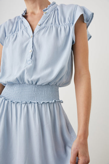 Amina Short Sleeve Mini Dress with Flutter Sleeves, a Ruffled Collar with Ruching, a Button Placket, and a Shirred Waist in Light Vintage Colorway - Front View Featured on Model 