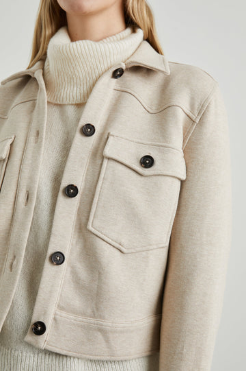 Easton Slightly Cropped Jacket with Button Closure, Two Chest Button Flap Pockets and Western Yokes in Heather Oatmeal Colorway - Front View Featured on Model