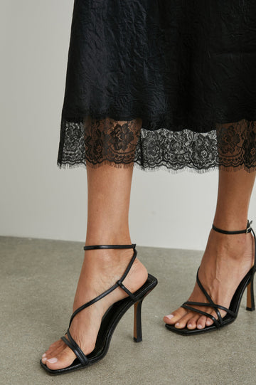Ebony Midi Skirt with Lace Trim in Black Colorway - Front View Featured on Model 
