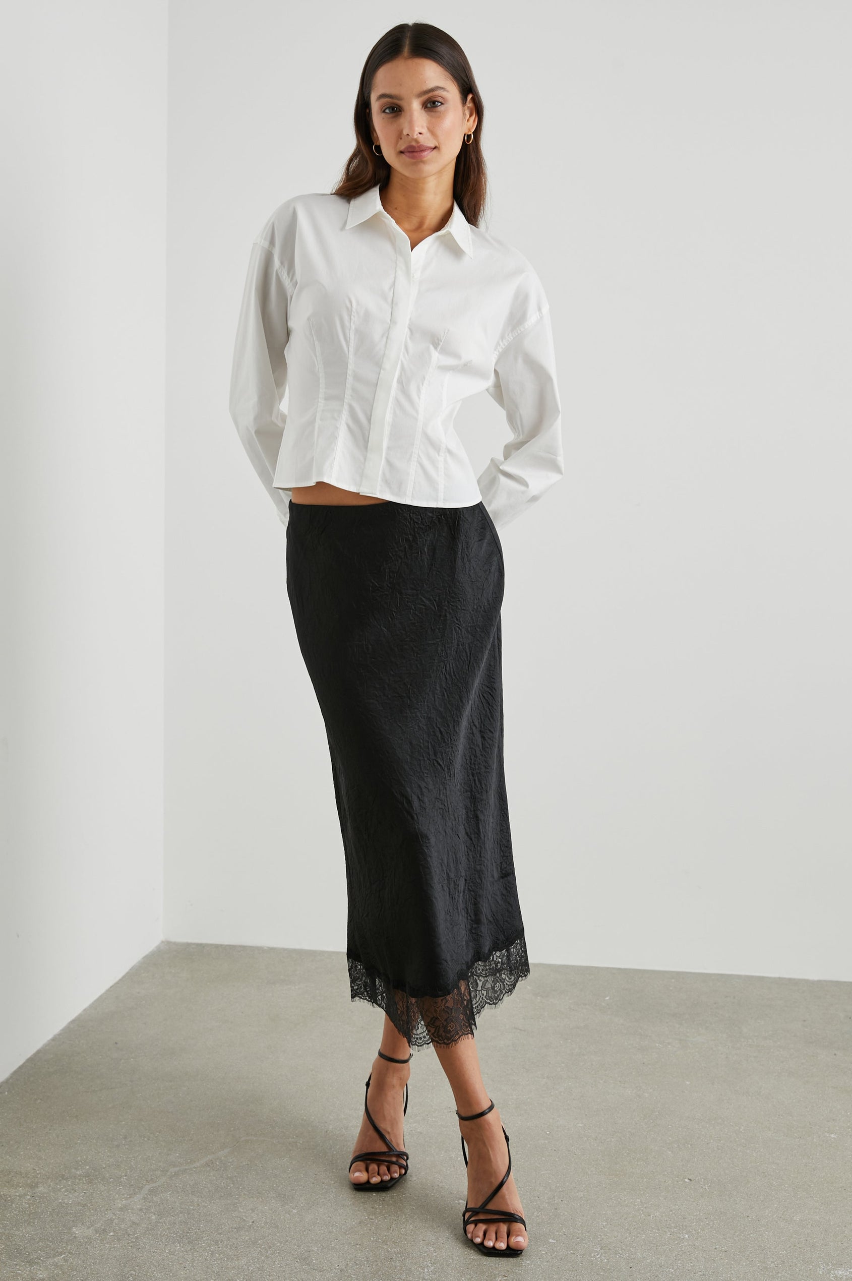 Ebony Midi Skirt with Lace Trim in Black Colorway - Front Full Body View Featured on Model 