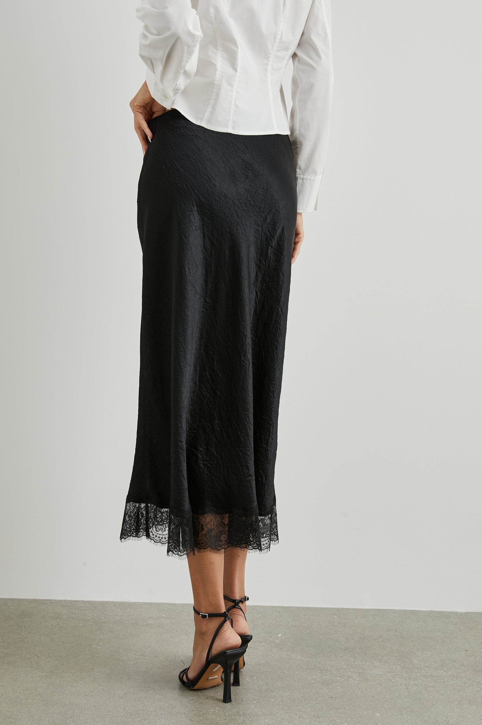 Ebony Midi Skirt with Lace Trim in Black Colorway - Back View Featured on Model 