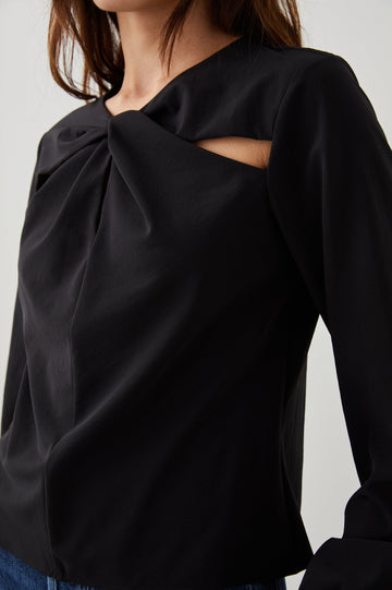 Eli Long-Sleeve Top with Twisted Fabric at the Neckline and a Cutout to the Left and Right of the Twist, a Vertical Seam Down the Front and a Keyhole at the Back in Black Colorway - Front View Featured on Model 