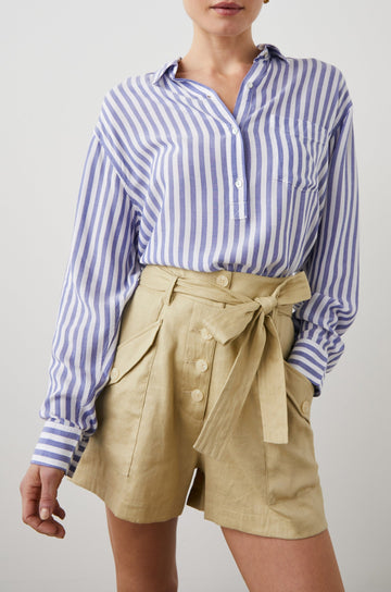Elle Long Sleeve Shirt with a Four Button Placket, Buttoned Cuffs, a Chest Pocket and a Collar in Blue White Stripe Colorway, Vertical Stripes - Front View Featured on Model