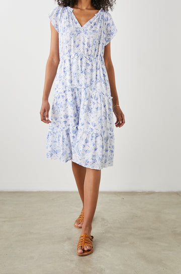 Juni Short Sleeve Midi Dress with a V Neck, Light Ruching along the Neckline, a Drawstring Waist, and a Tiered Skirt in Blue Blossoms Colorway, on White - Front Full Body View Featured on Model