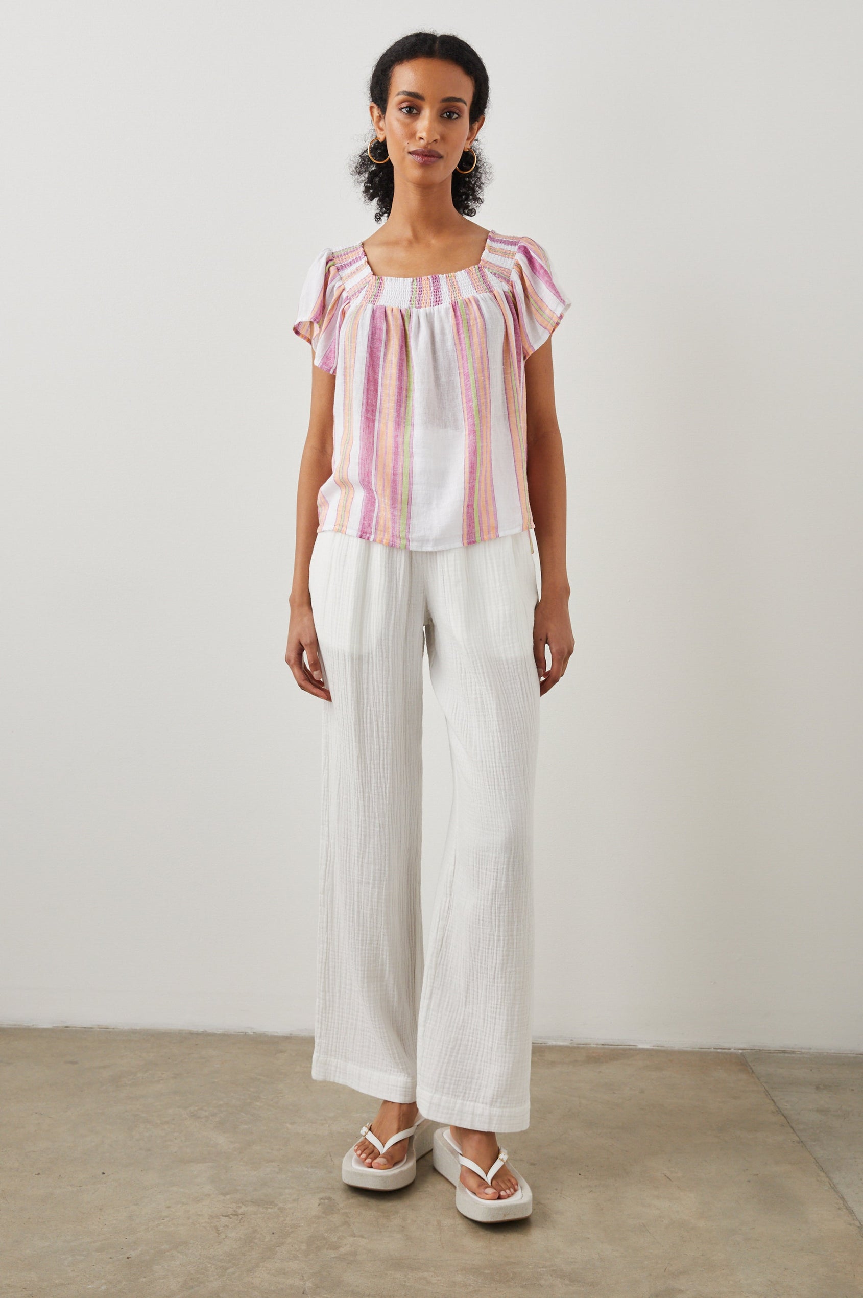 Sonora Short Sleeve Top with a Scoop Neckline and Shirring at the Neckline in Hibiscus Stripe Colorway, Vertical Stripes in Green, Orange, Pink and White - Front Full Body View Featured on Model 