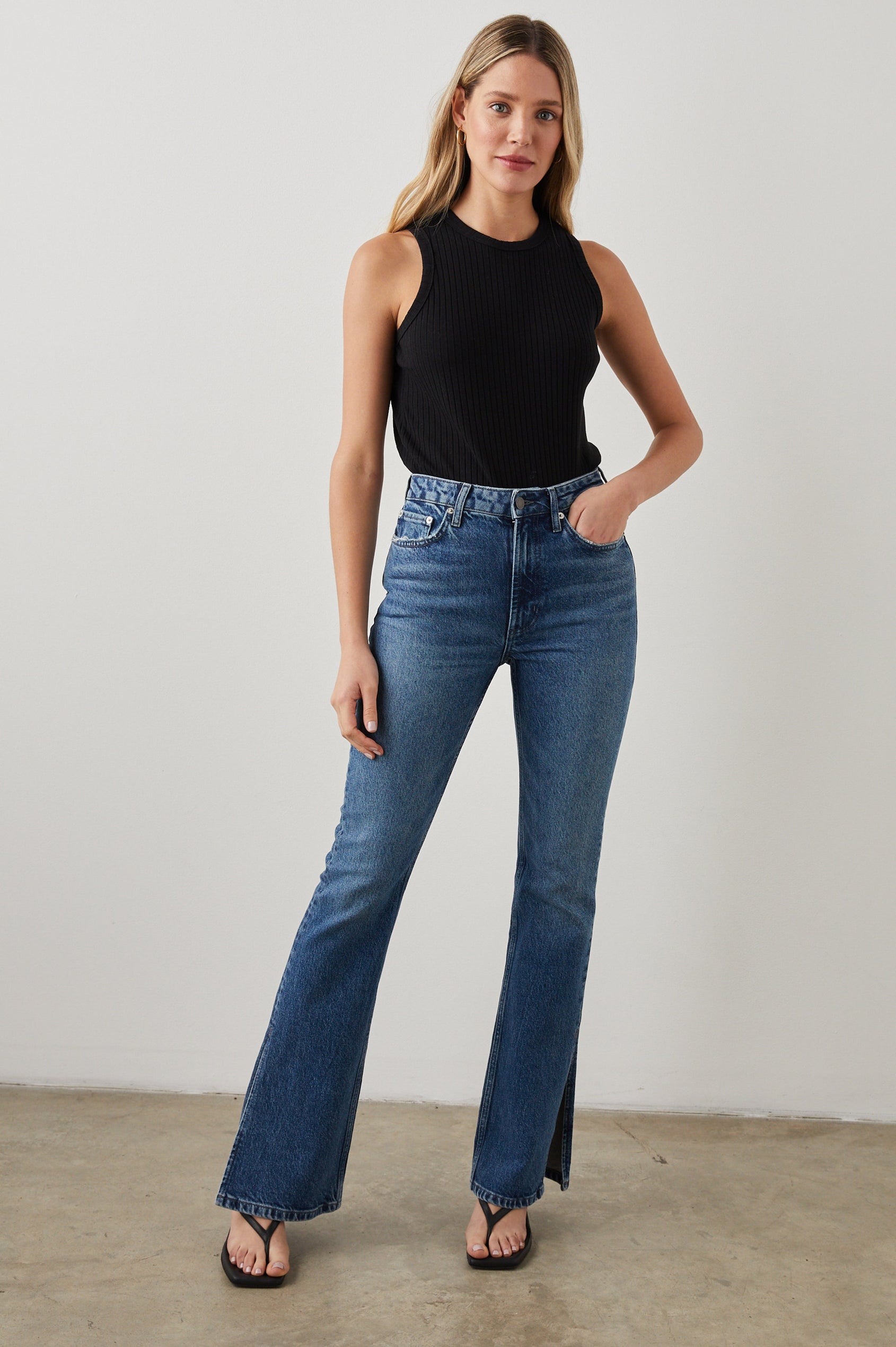 Sunset Crop Slim Fare Jeans with Outer Hem Slits, Belt Loops, Two Front Pockets plus a Coin Pocket and Two Back Patch Pockets in Navy Stone Colorway - Front Full Body View Featured on Model