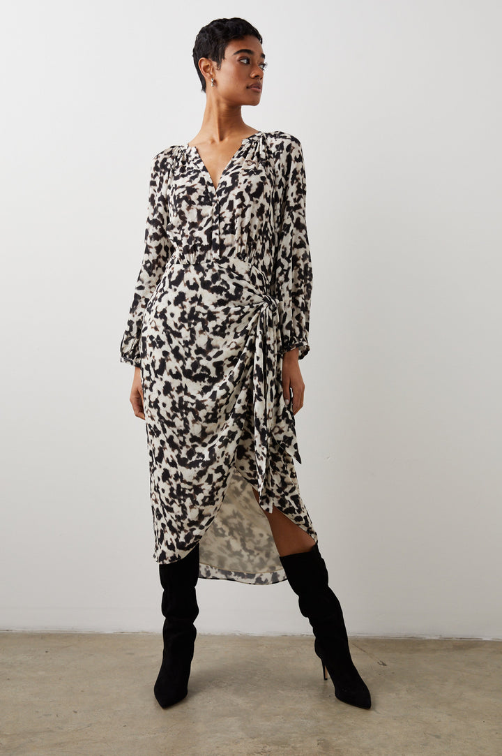 Tyra Long-Sleeve Midi Dress with a V Neck Placket, and a Fabric Tie at the Waist in Blurred Cheetah Colorway, a Black and Brown Pattern on White - Front View Featured on Model 