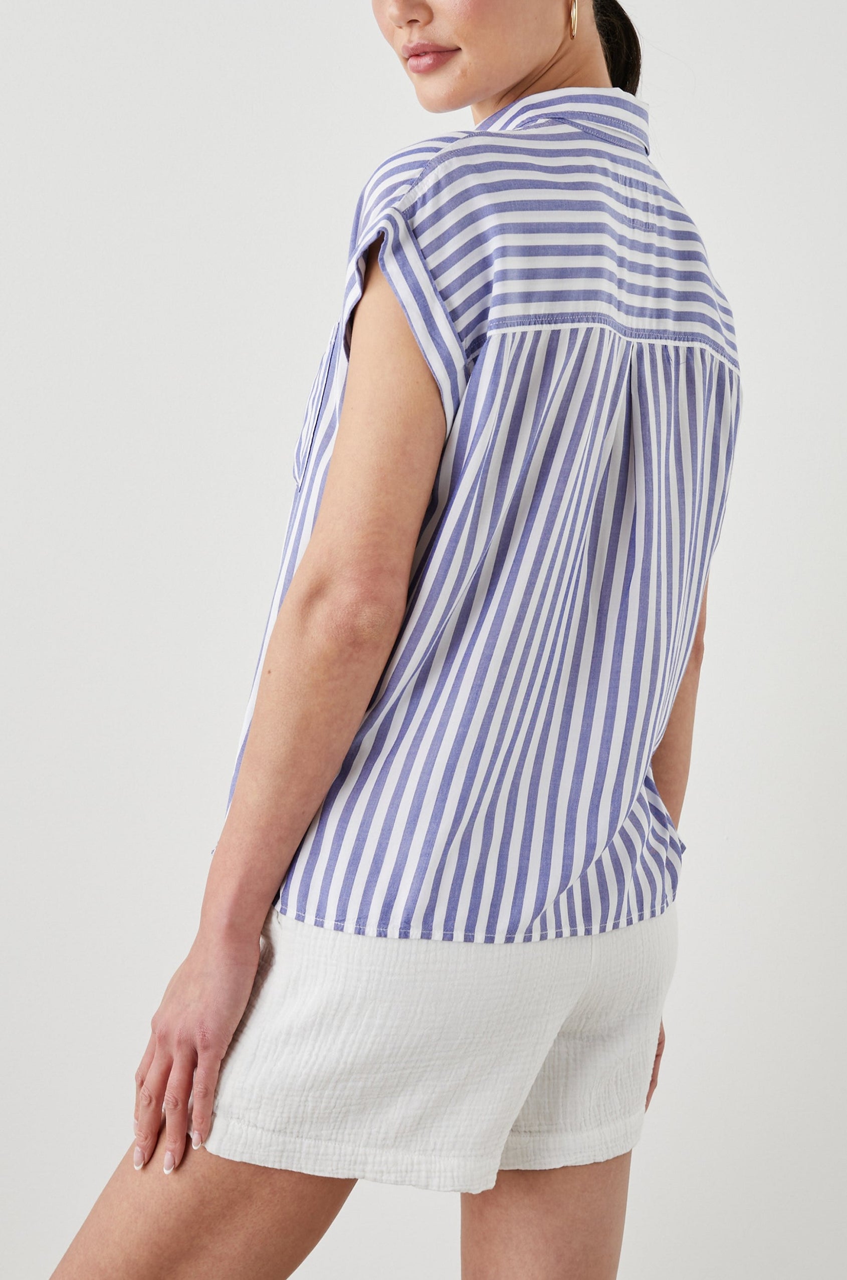 Whitney Short Rolled Sleeves Button Up with a Chest Patch Pocket and Short Side Slits in Blue White Stripe Colorway, with vertical stripes - Back View Featured on Model