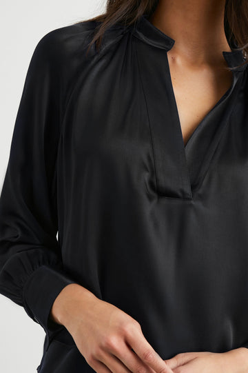 Wynna Long-Sleeve Top with a Deep V Neck and Ruching above the Cuffs and at the Neckline in Black Colorway - Front View Featured on Model